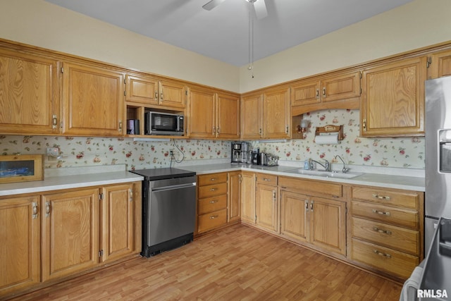 608 S Main St, Port Byron, IL 61275 - kitchen featuring light wood-style flooring, light countertops, ceiling fan, wallpapered walls, and stove