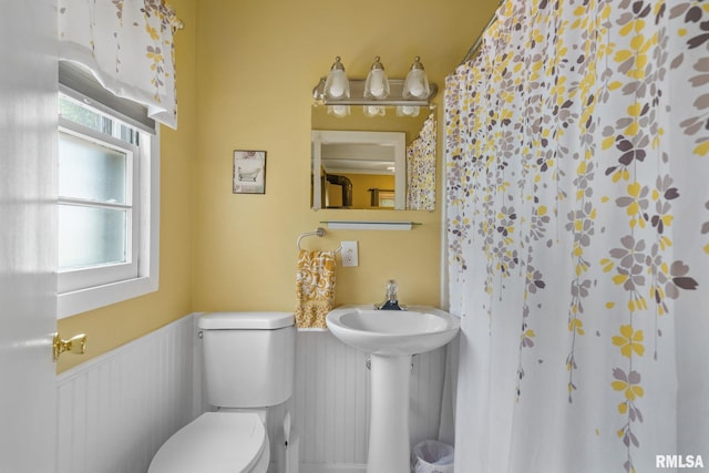 608 S Main St, Port Byron, IL 61275 - bathroom with a wainscoted wall and curtained shower