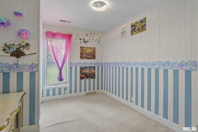 608 S Main St, Port Byron, IL 61275 - carpeted spare room with wallpapered walls and wooden walls