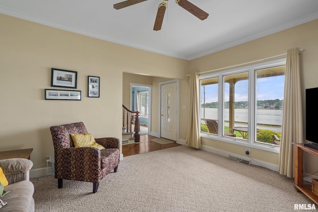 608 S Main St, Port Byron, IL 61275 - living area featuring carpet flooring, a ceiling fan, stairs, and ornamental molding