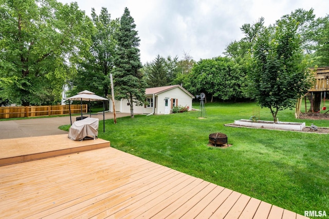 608 S Main St, Port Byron, IL 61275 - deck with an outdoor fire pit, a gazebo, an outdoor structure, and view of scattered trees