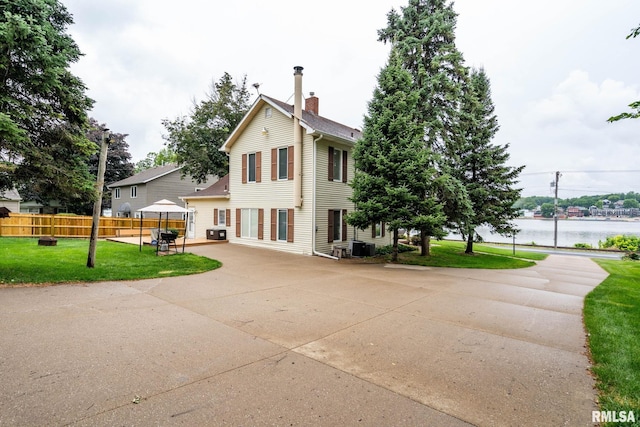 608 S Main St, Port Byron, IL 61275 - back of house featuring a patio, a chimney, and a water view