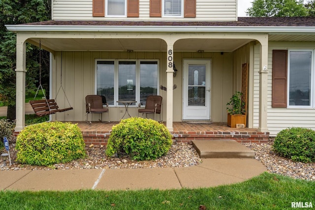 608 S Main St, Port Byron, IL 61275 - view of exterior entry featuring a porch and a shingled roof