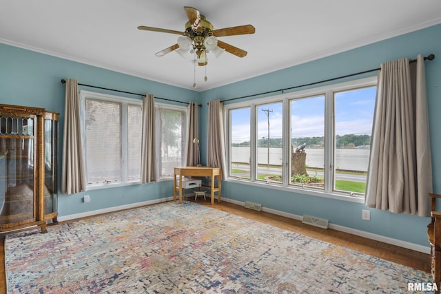 608 S Main St, Port Byron, IL 61275 - empty room featuring a ceiling fan, crown molding, wood finished floors, and a water view
