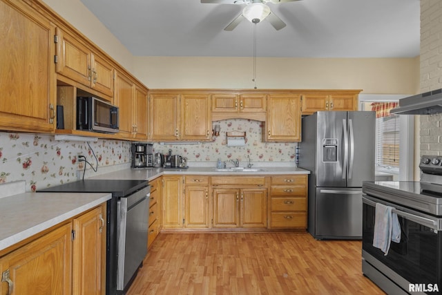 608 S Main St, Port Byron, IL 61275 - kitchen featuring stainless steel appliances, light wood finished floors, a ceiling fan, and light countertops