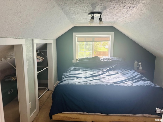 119 S Elm St, Williamsfield, IL 61489 - bedroom with a textured ceiling, carpet, and vaulted ceiling