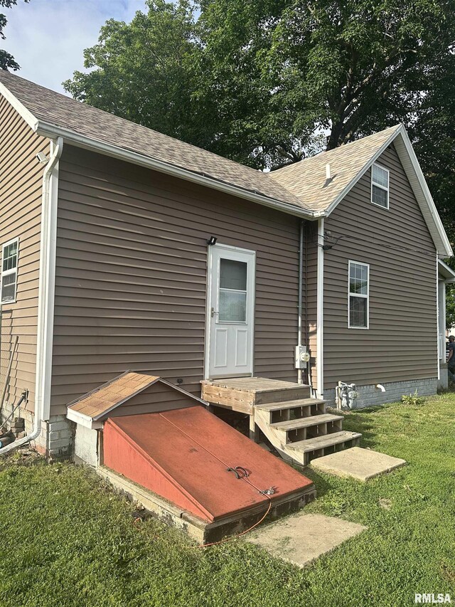 119 S Elm St, Williamsfield, IL 61489 - exterior view of gutters, a downspout, a shingled roof, electric meter, and a bulkhead entry
