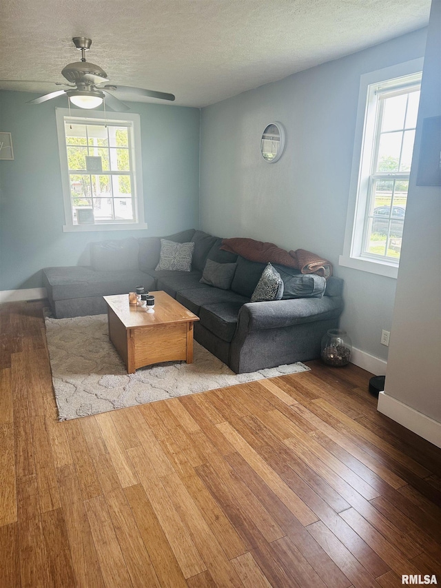 119 S Elm St, Williamsfield, IL 61489 - living area with hardwood / wood-style floors, a ceiling fan, a textured ceiling, and baseboards