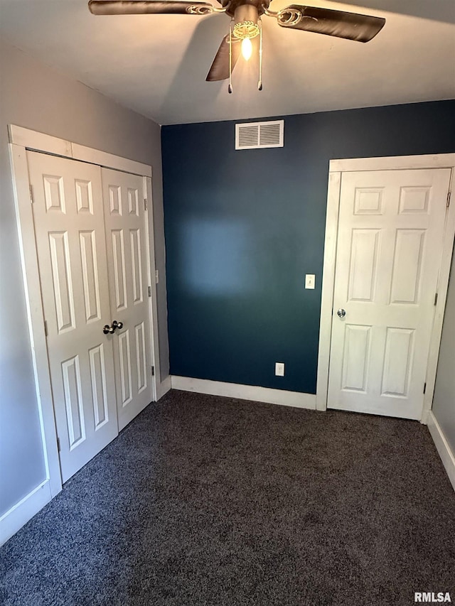 119 S Elm St, Williamsfield, IL 61489 - unfurnished bedroom with dark colored carpet, baseboards, ceiling fan, and a closet