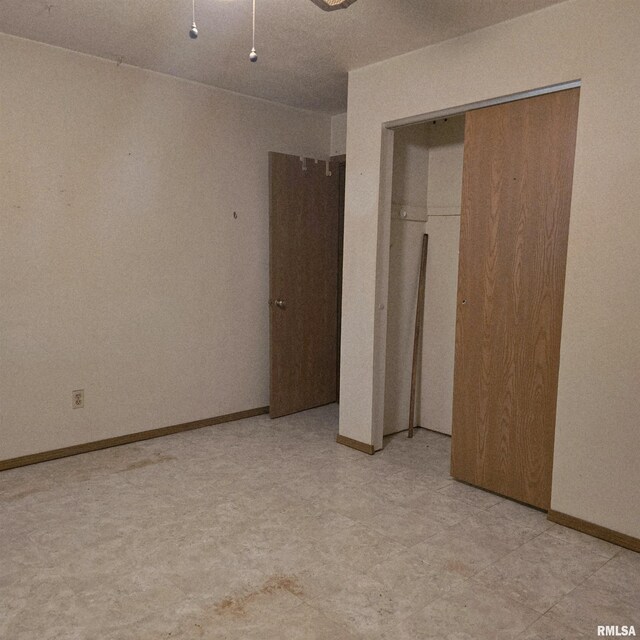 414 S Clayton St, Benton, IL 62812 - unfurnished bedroom featuring a closet and baseboards
