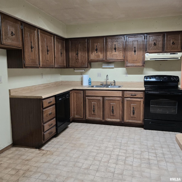 414 S Clayton St, Benton, IL 62812 - kitchen featuring black appliances, under cabinet range hood, a sink, light countertops, and dark brown cabinetry