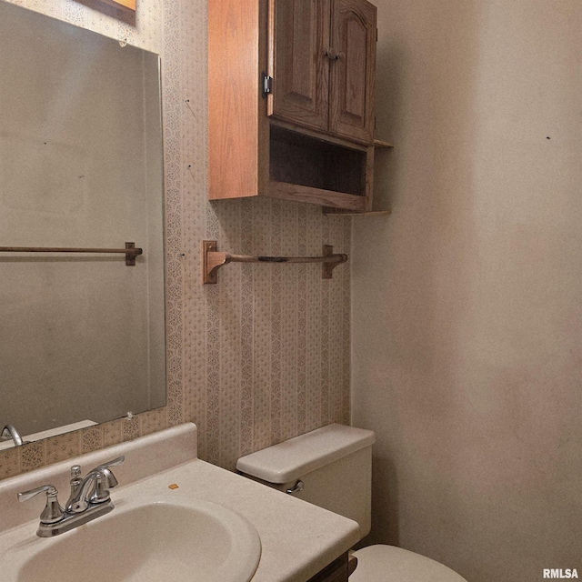 414 S Clayton St, Benton, IL 62812 - bathroom with wallpapered walls, toilet, and vanity