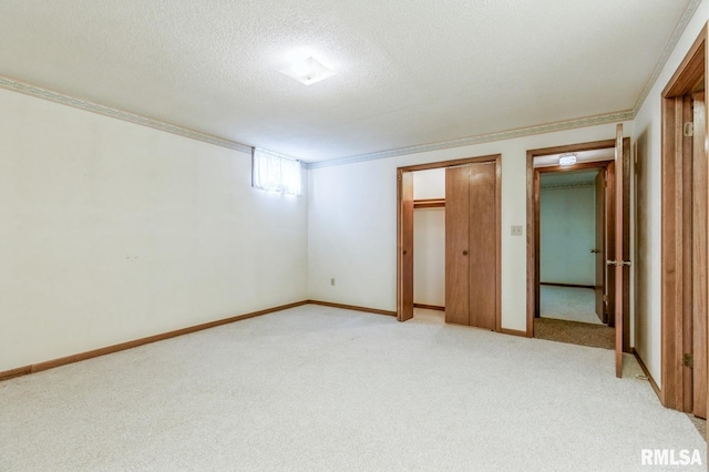 404 10th St, Lowden, IA 52255 - unfurnished bedroom featuring light colored carpet, a textured ceiling, baseboards, and crown molding