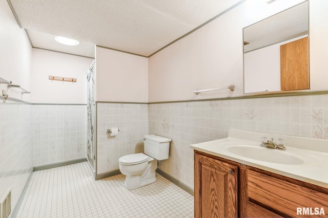 404 10th St, Lowden, IA 52255 - full bathroom with toilet, tile walls, vanity, a shower with curtain, and tile patterned flooring