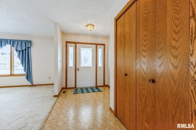404 10th St, Lowden, IA 52255 - entryway featuring baseboards and a textured ceiling