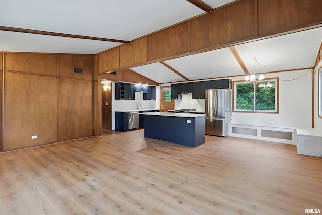 2402 Middle Rd, Davenport, IA 52803 - kitchen with appliances with stainless steel finishes, healthy amount of natural light, light countertops, a kitchen island, and vaulted ceiling