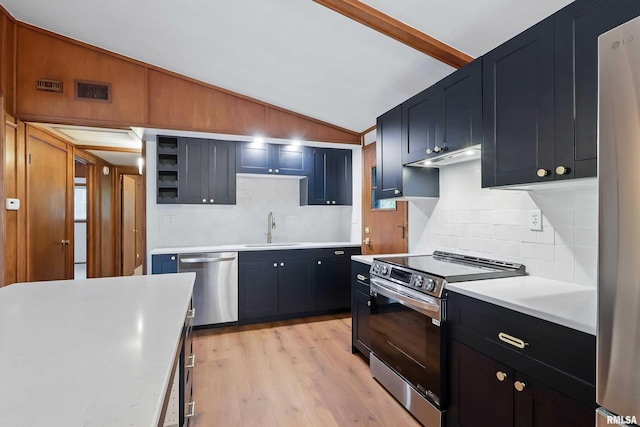 2402 Middle Rd, Davenport, IA 52803 - kitchen featuring stainless steel appliances, a sink, vaulted ceiling, decorative backsplash, and light countertops