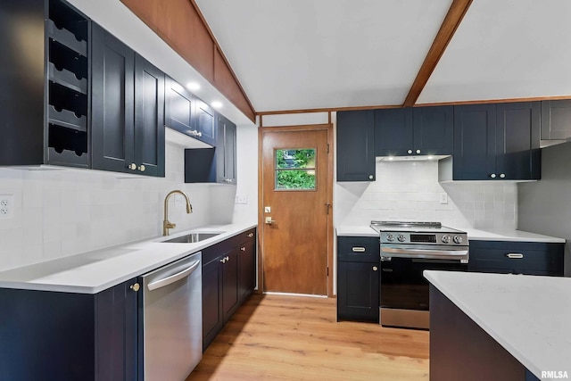 2402 Middle Rd, Davenport, IA 52803 - kitchen with stainless steel appliances, a sink, tasteful backsplash, and light countertops