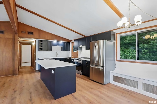 2402 Middle Rd, Davenport, IA 52803 - kitchen with appliances with stainless steel finishes, a chandelier, light countertops, dark cabinetry, and radiator