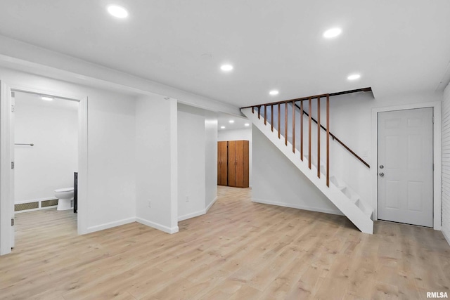 2402 Middle Rd, Davenport, IA 52803 - finished below grade area with stairs, recessed lighting, light wood finished floors, and baseboards