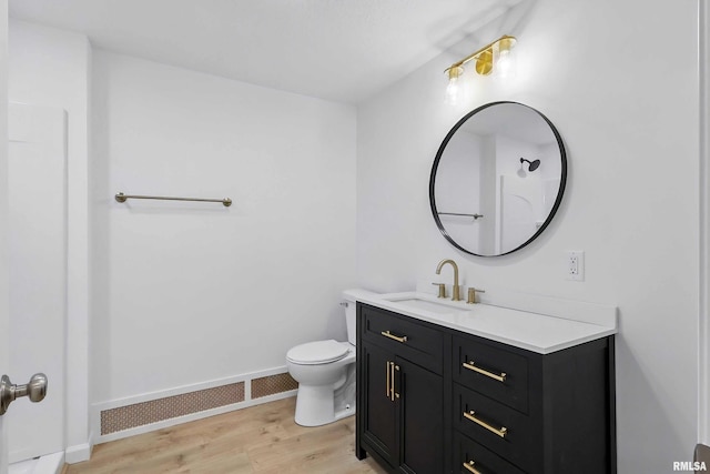 2402 Middle Rd, Davenport, IA 52803 - bathroom with vanity, wood finished floors, toilet, and baseboards