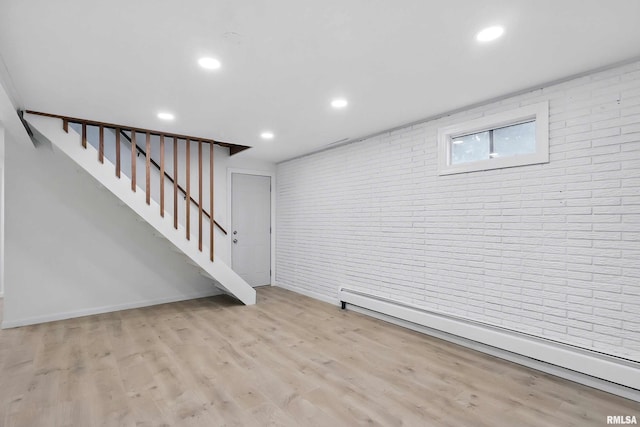 2402 Middle Rd, Davenport, IA 52803 - below grade area featuring baseboard heating, brick wall, stairs, wood finished floors, and recessed lighting
