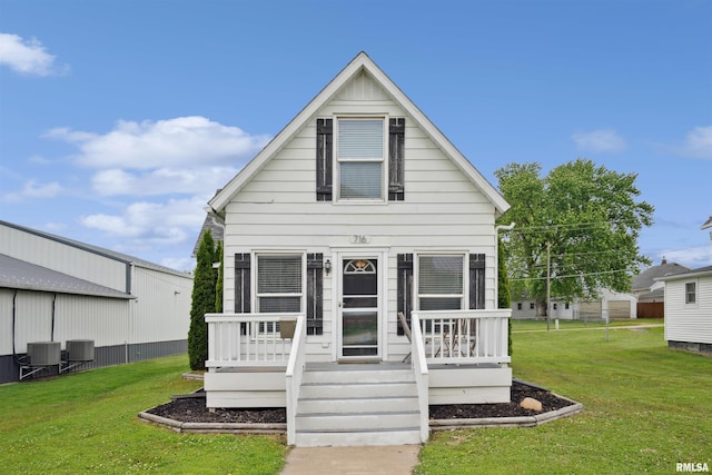 716 10th St, De Witt, IA 52742 - view of front of house featuring a front lawn and central air condition unit