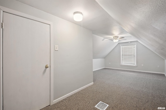 716 10th St, De Witt, IA 52742 - additional living space featuring carpet floors, vaulted ceiling, baseboards, and a ceiling fan