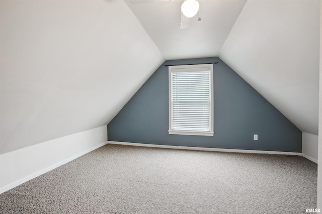 716 10th St, De Witt, IA 52742 - additional living space with carpet floors, vaulted ceiling, baseboards, and a ceiling fan