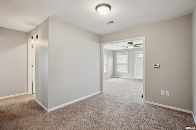 716 10th St, De Witt, IA 52742 - carpeted empty room featuring ceiling fan and baseboards