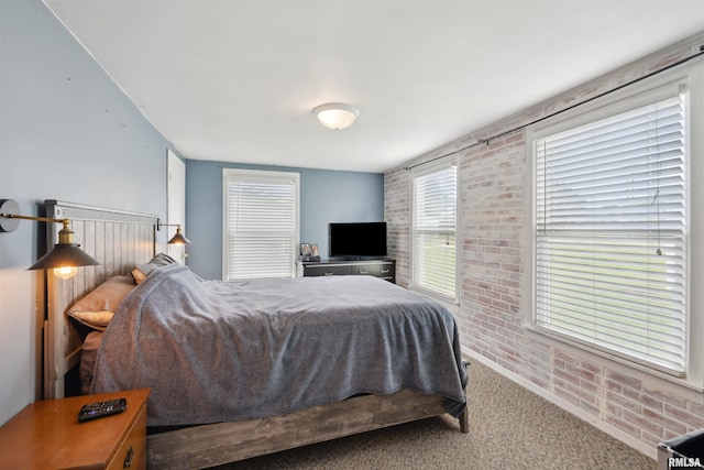 716 10th St, De Witt, IA 52742 - carpeted bedroom with brick wall