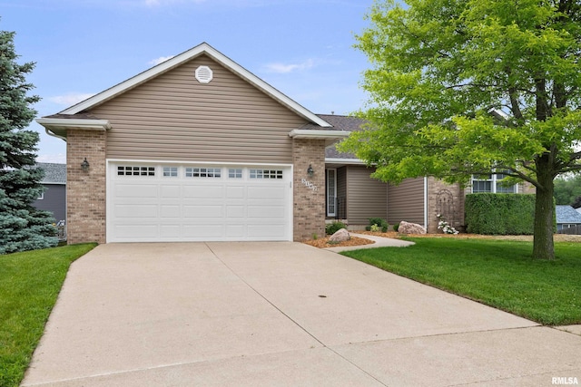 5142 Fillmore Ct, Davenport, IA 52806 - view of front of house with brick siding, concrete driveway, a front lawn, and a garage