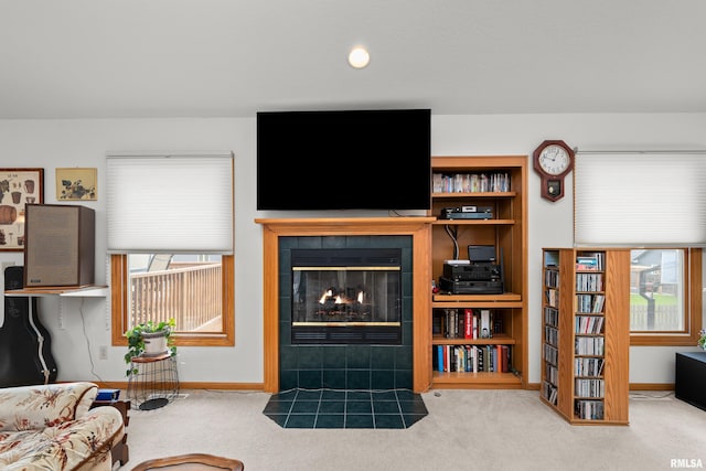 5142 Fillmore Ct, Davenport, IA 52806 - carpeted living area with a tile fireplace, baseboards, and healthy amount of natural light