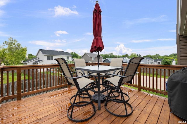 5142 Fillmore Ct, Davenport, IA 52806 - wooden deck featuring outdoor dining space, grilling area, and a residential view