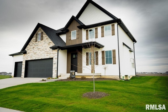 6654 Meghan Ave, Bettendorf, IA 52722 - view of front of home featuring a front lawn, concrete driveway, an attached garage, and stone siding