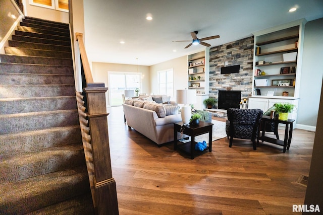 6654 Meghan Ave, Bettendorf, IA 52722 - living area featuring a ceiling fan, stairway, dark wood-style floors, recessed lighting, and built in shelves