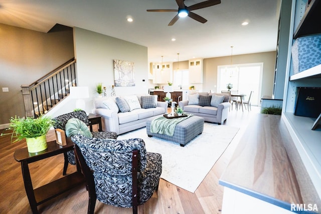 6654 Meghan Ave, Bettendorf, IA 52722 - living area featuring wood finished floors, ceiling fan, recessed lighting, and stairs