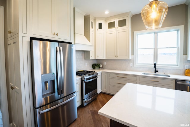 6654 Meghan Ave, Bettendorf, IA 52722 - kitchen featuring appliances with stainless steel finishes, a sink, dark wood-style floors, tasteful backsplash, and recessed lighting