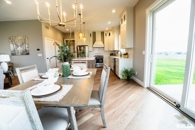 6654 Meghan Ave, Bettendorf, IA 52722 - dining area with a chandelier, plenty of natural light, light wood-style floors, recessed lighting, and baseboards