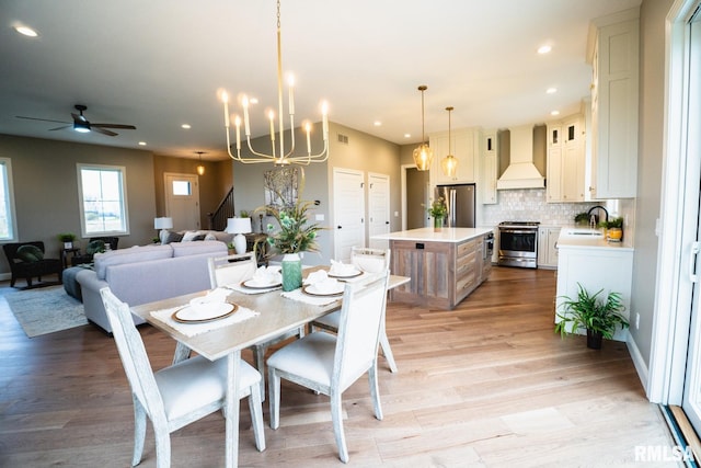 6654 Meghan Ave, Bettendorf, IA 52722 - dining area with ceiling fan, light wood finished floors, a chandelier, and recessed lighting