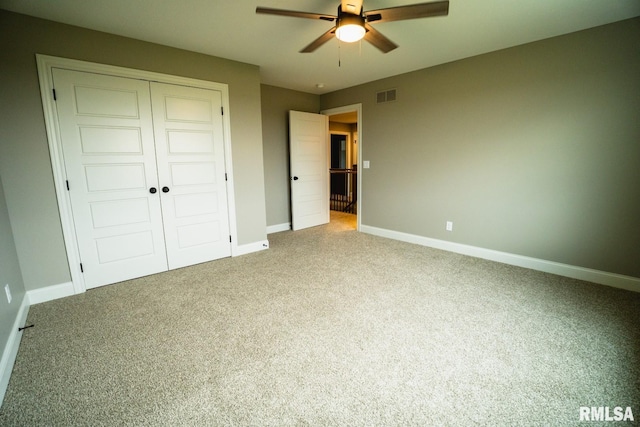 6654 Meghan Ave, Bettendorf, IA 52722 - unfurnished bedroom featuring light colored carpet, baseboards, a closet, and a ceiling fan