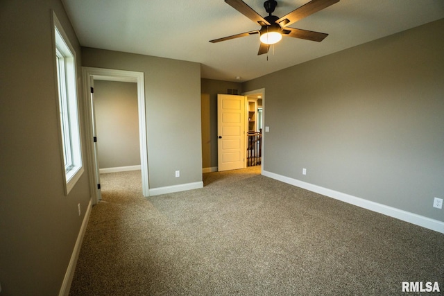 6654 Meghan Ave, Bettendorf, IA 52722 - unfurnished bedroom featuring baseboards, carpet flooring, and a ceiling fan