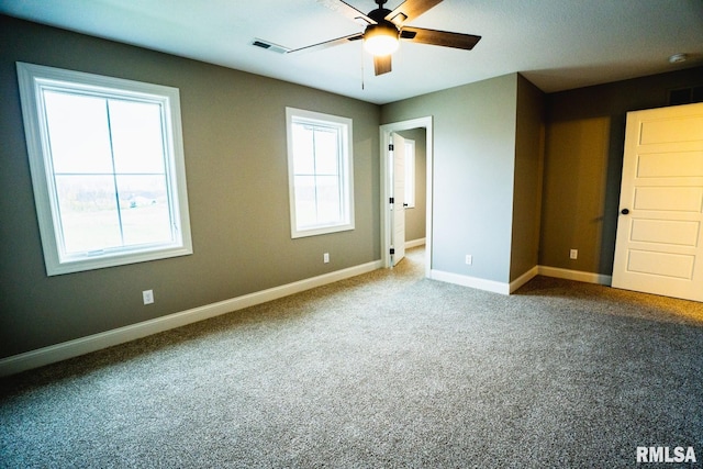 6654 Meghan Ave, Bettendorf, IA 52722 - unfurnished bedroom featuring carpet flooring, baseboards, and ceiling fan