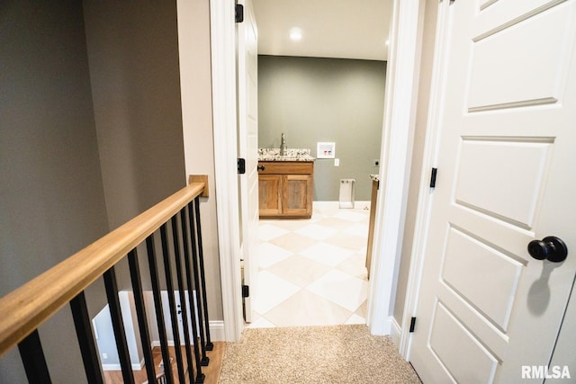 6654 Meghan Ave, Bettendorf, IA 52722 - hallway with light colored carpet, recessed lighting, and a sink