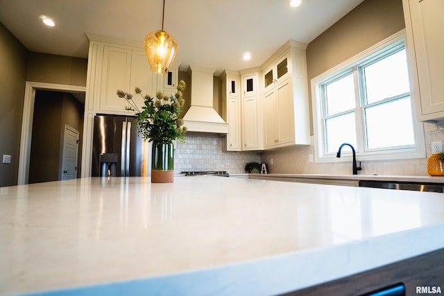 6654 Meghan Ave, Bettendorf, IA 52722 - kitchen with premium range hood, light countertops, tasteful backsplash, a sink, and recessed lighting