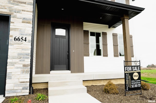 6654 Meghan Ave, Bettendorf, IA 52722 - doorway to property with stone siding