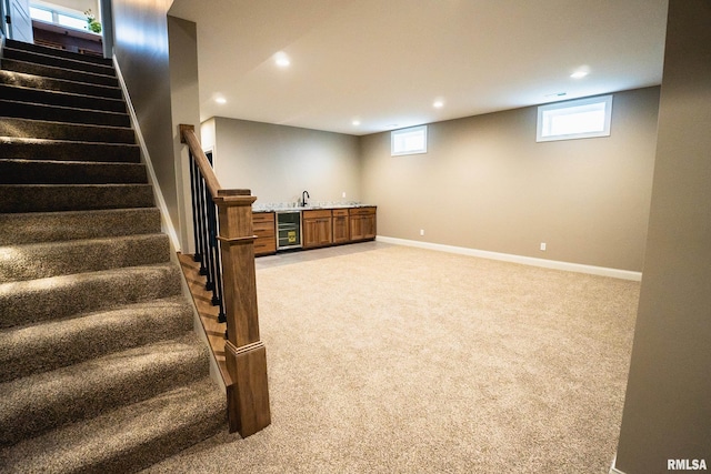 6654 Meghan Ave, Bettendorf, IA 52722 - below grade area featuring beverage cooler, light carpet, recessed lighting, stairway, and wet bar