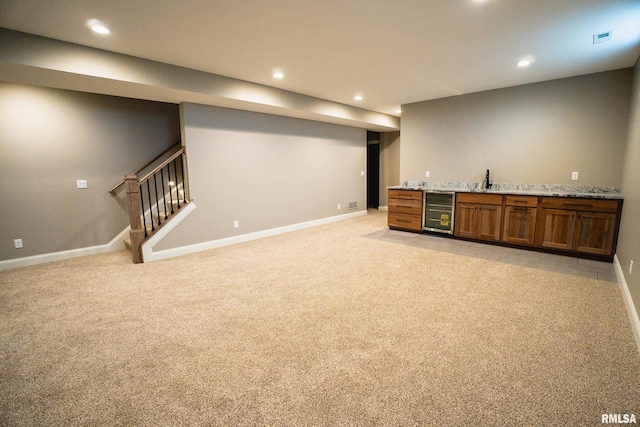 6654 Meghan Ave, Bettendorf, IA 52722 - finished basement with beverage cooler, bar with sink, baseboards, recessed lighting, and light colored carpet