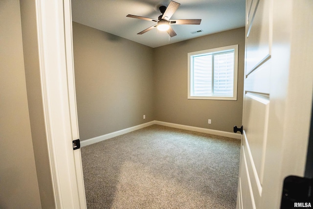 6654 Meghan Ave, Bettendorf, IA 52722 - spare room with carpet flooring, a ceiling fan, and baseboards