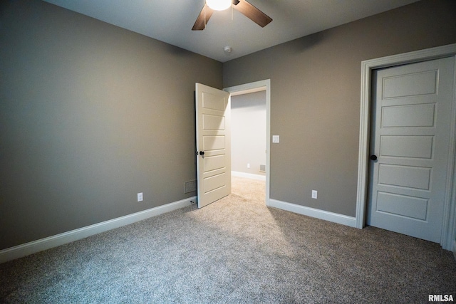 6654 Meghan Ave, Bettendorf, IA 52722 - unfurnished bedroom with carpet, baseboards, and ceiling fan